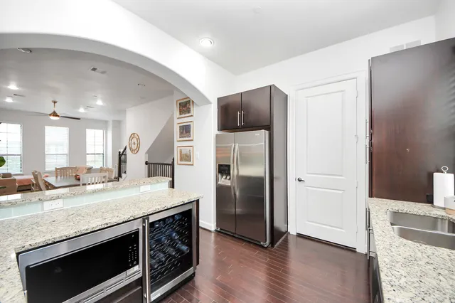 a kitchen with stainless steel appliances granite countertop a refrigerator and a sink