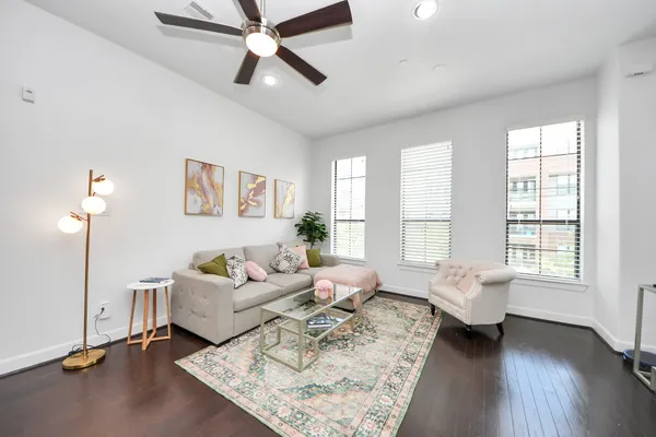 a living room with furniture a bed and a window