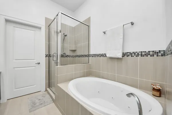 a bathroom with a tub and a shower