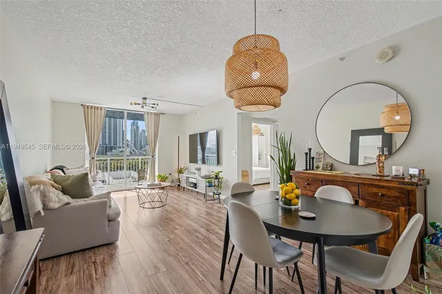 a living room with furniture a table and large windows