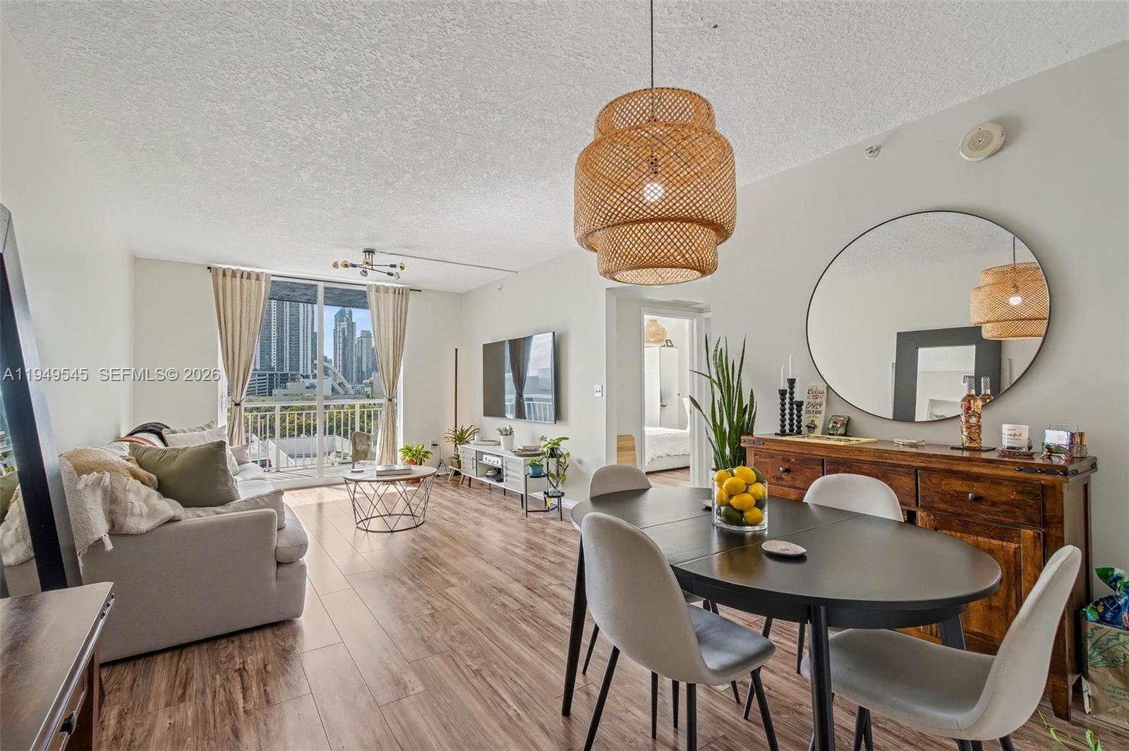 a living room with furniture a table and large windows