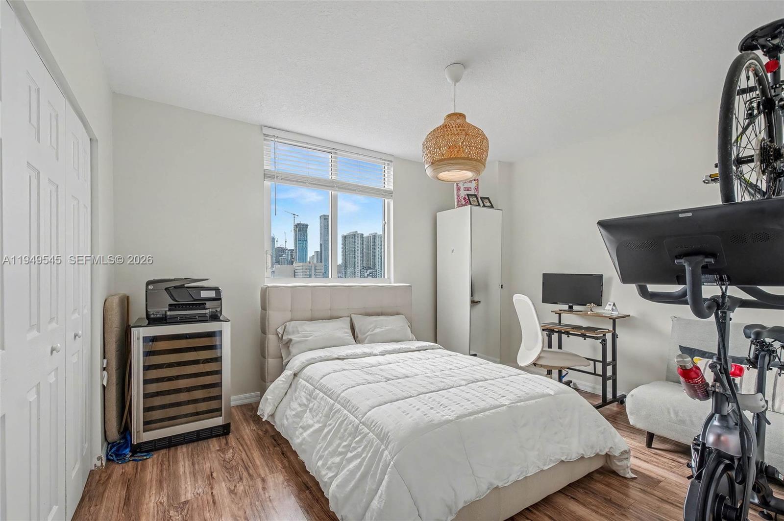 275 Northeast 18th Street, Unit 703 Miami, FL 33132 - Photo 11 of 28 a bedroom with a bed and wooden floor