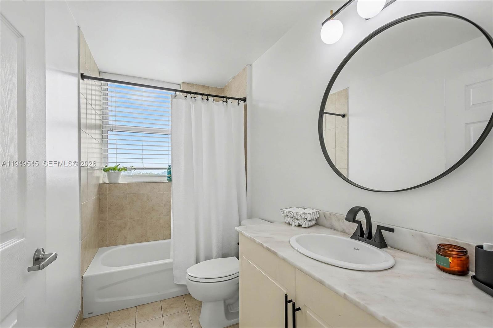 275 Northeast 18th Street, Unit 703 Miami, FL 33132 - Photo 14 of 28 a bathroom with a sink a toilet and a mirror