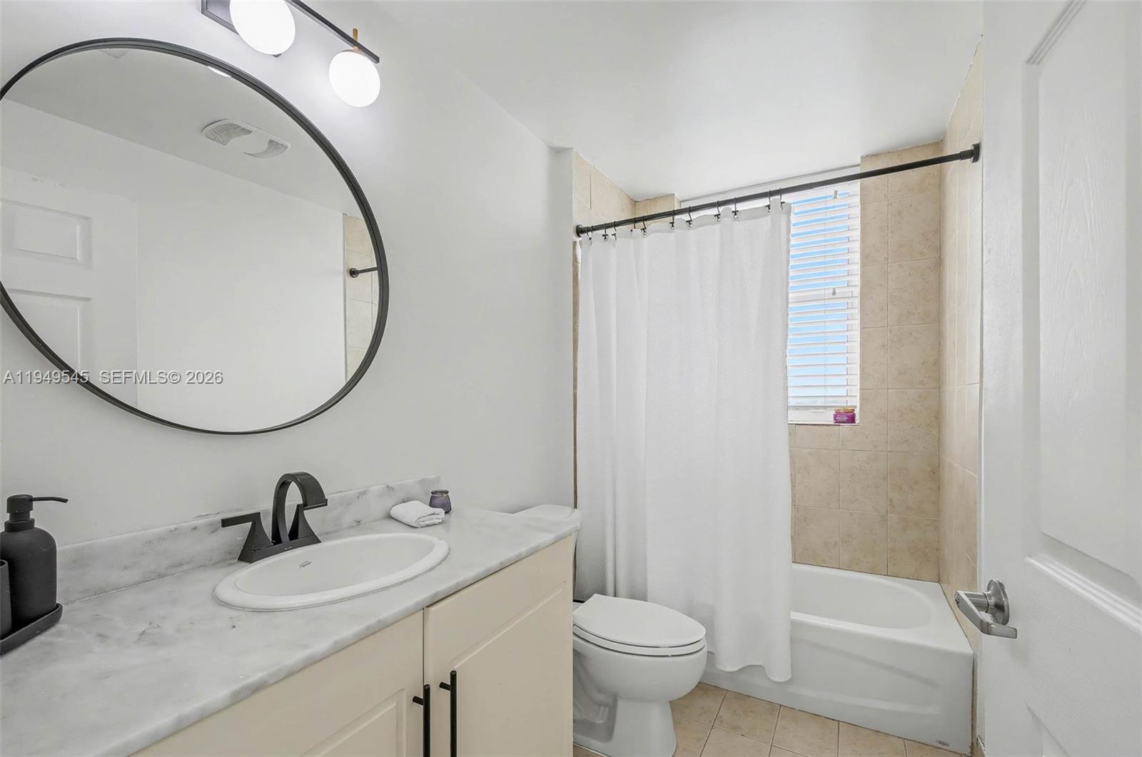 275 Northeast 18th Street, Unit 703 Miami, FL 33132 - Photo 15 of 28 a bathroom with a granite countertop sink toilet and a mirror