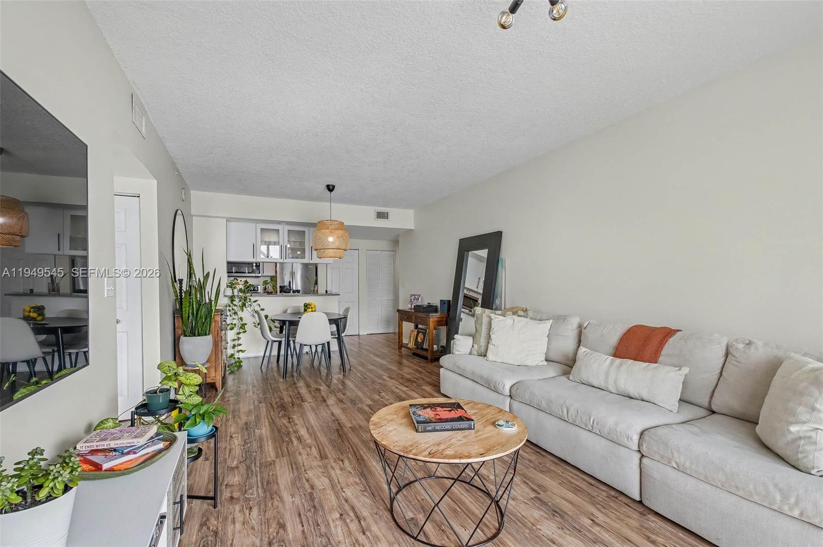 275 Northeast 18th Street, Unit 703 Miami, FL 33132 - Photo 2 of 28 a living room with furniture and wooden floor