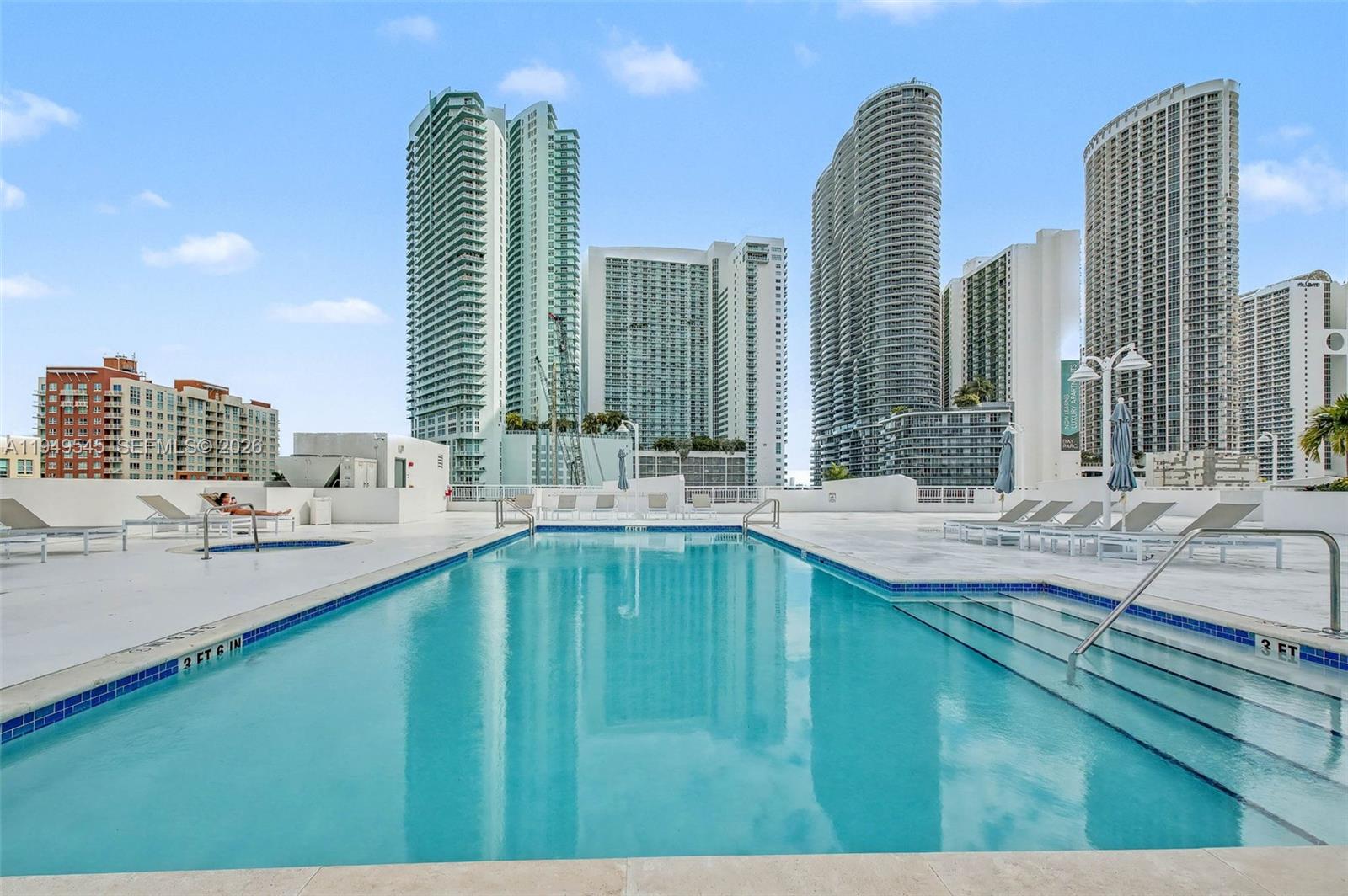 275 Northeast 18th Street, Unit 703 Miami, FL 33132 - Photo 26 of 28 a large swimming pool with a couple of chairs