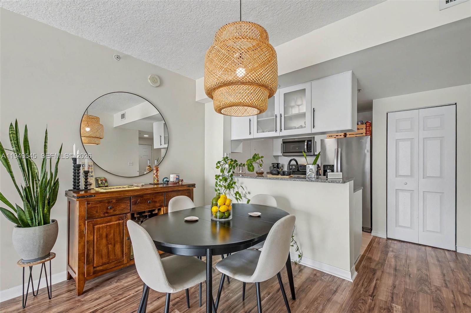 275 Northeast 18th Street, Unit 703 Miami, FL 33132 - Photo 5 of 28 a view of a dining room with furniture a potted plant and wooden floor