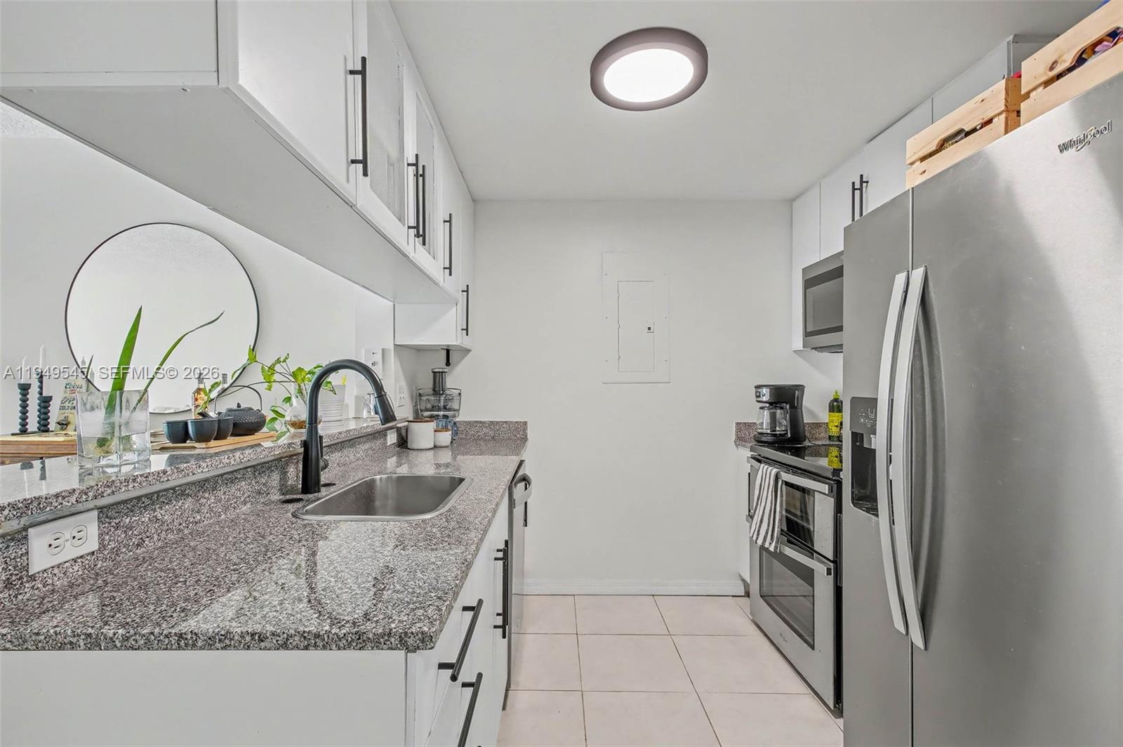 275 Northeast 18th Street, Unit 703 Miami, FL 33132 - Photo 6 of 28 a kitchen with stainless steel appliances granite countertop a refrigerator and a sink