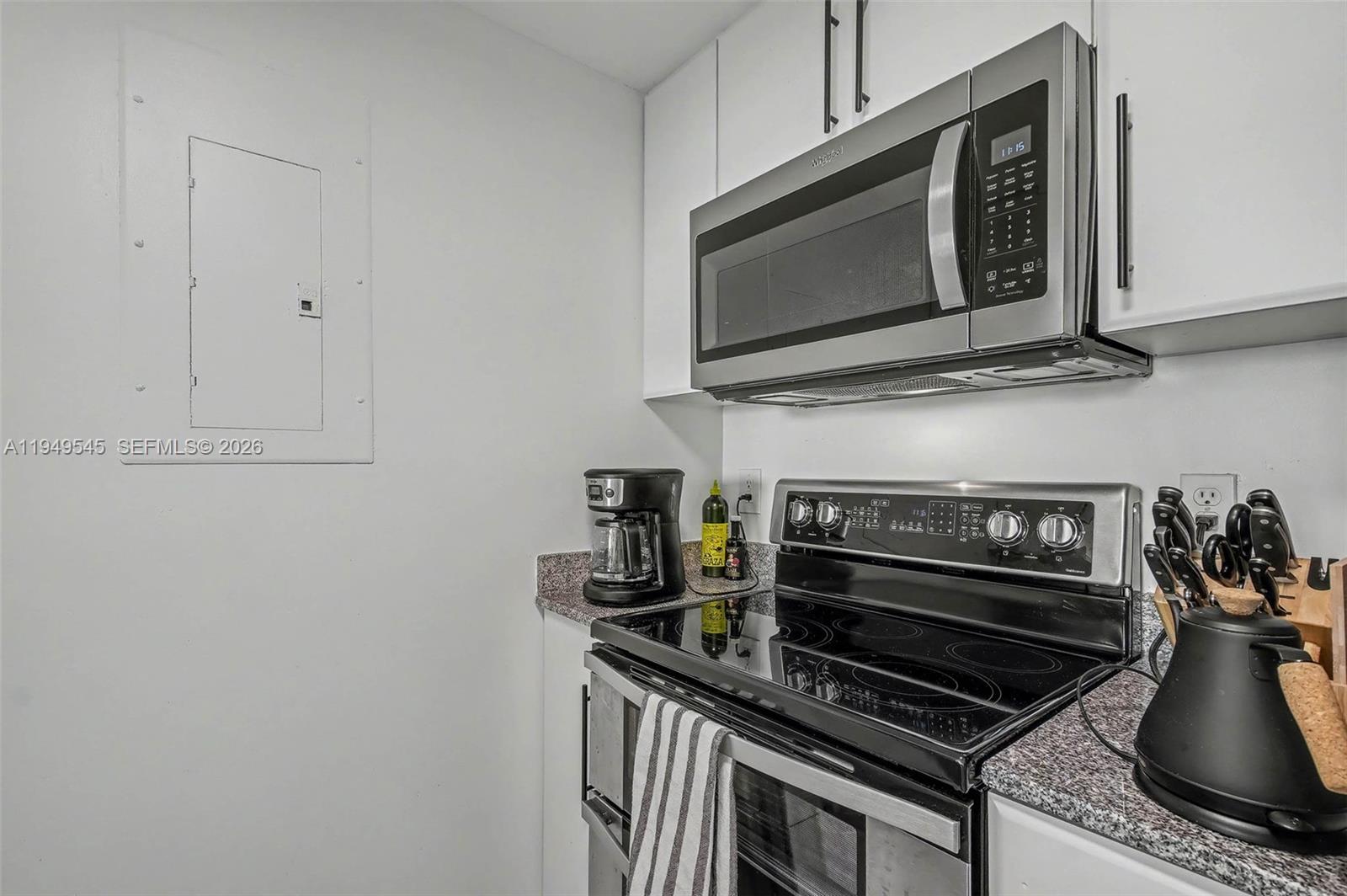 275 Northeast 18th Street, Unit 703 Miami, FL 33132 - Photo 8 of 28 a kitchen with a stove and a microwave