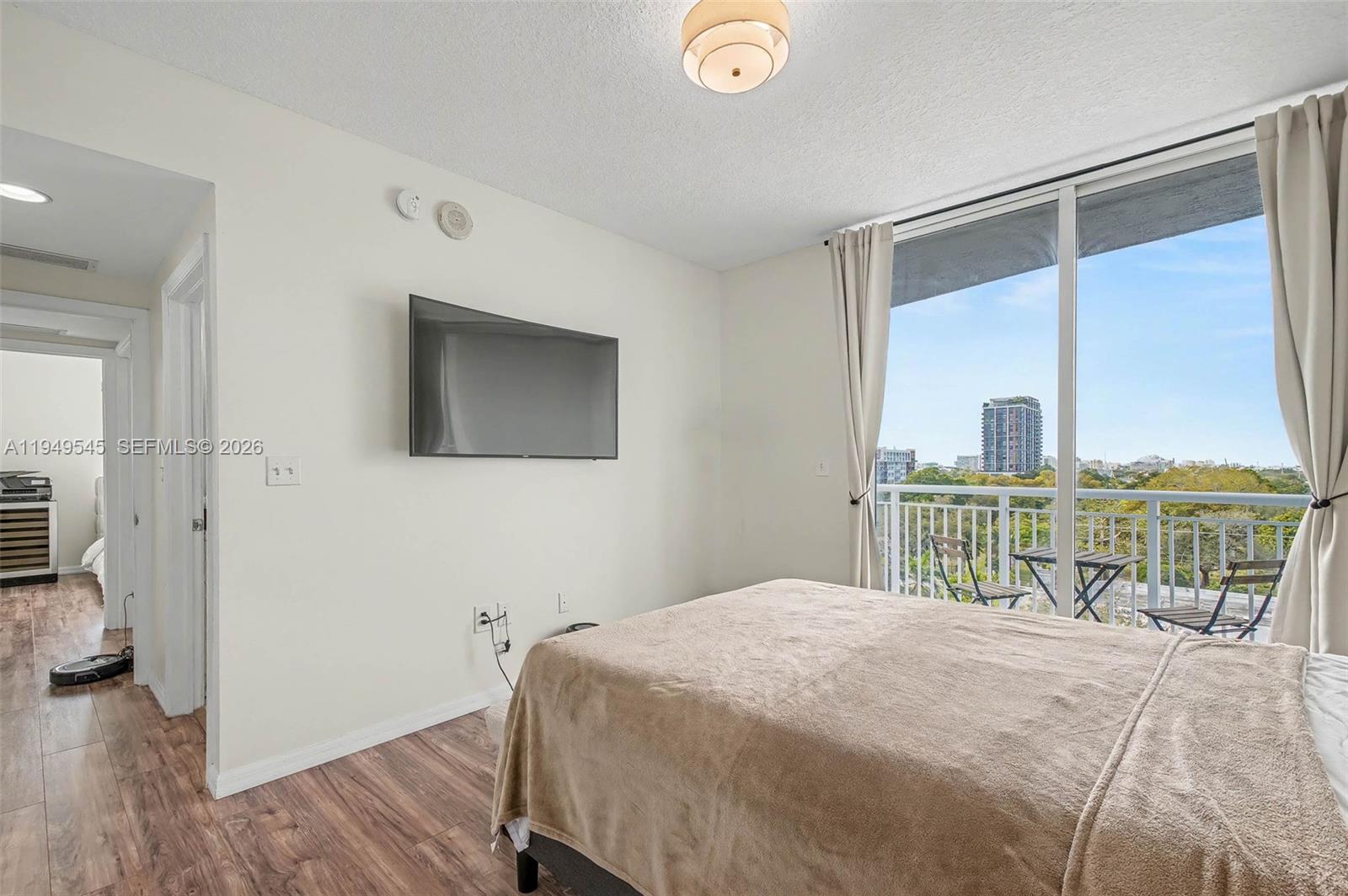 275 Northeast 18th Street, Unit 703 Miami, FL 33132 - Photo 9 of 28 a bedroom with a large bed and a tv