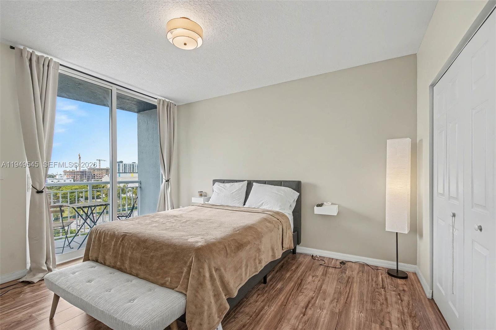 275 Northeast 18th Street, Unit 703 Miami, FL 33132 - Photo 10 of 28 a bedroom with a bed and a window