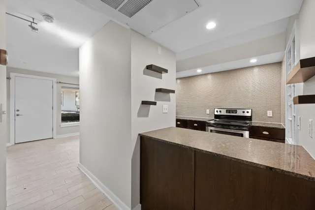 a kitchen with stainless steel appliances a sink and a refrigerator