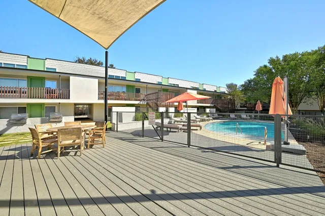 a view of a patio with table and chairs floor to ceiling with wooden floor
