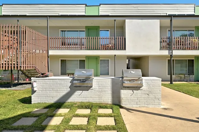 a view of a patio with couches table and chairs with potted plants