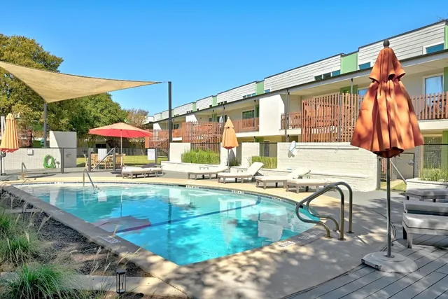 a view of a swimming pool with a lounge chairs