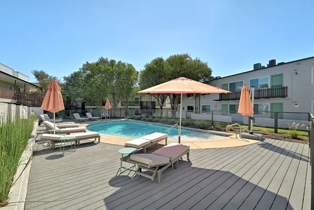 an outdoor space with pool and furniture