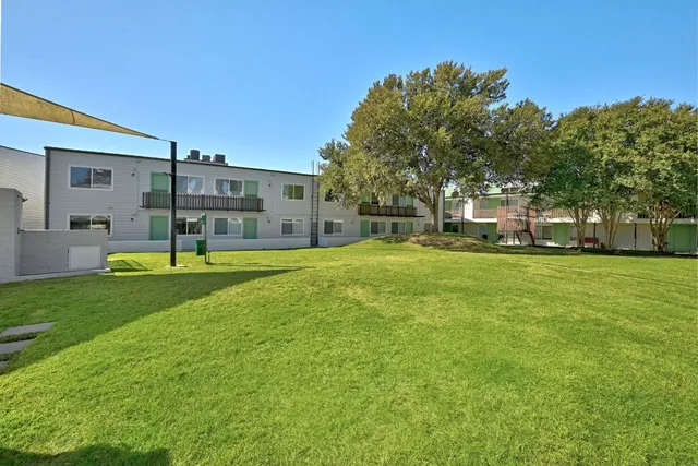 a view of a house with a backyard patio and sitting area