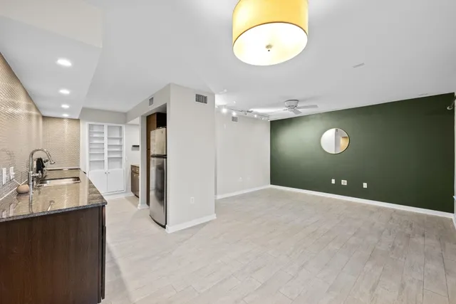 a view of a kitchen with a sink dishwasher refrigerator and a sink