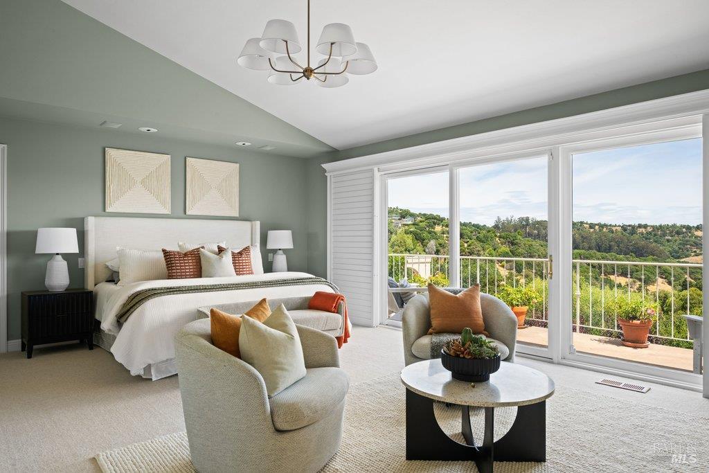 82 McNear Drive San Rafael, CA 94901 - Photo 30 of 54 a bedroom with a bed and a chandelier
