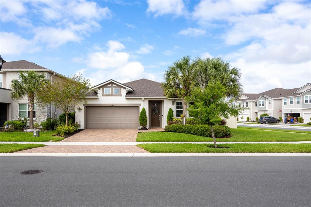 2485 Morninglight Drive Lutz, FL 33558 - Photo 1 of 1 a view of a white house next to a yard with big trees