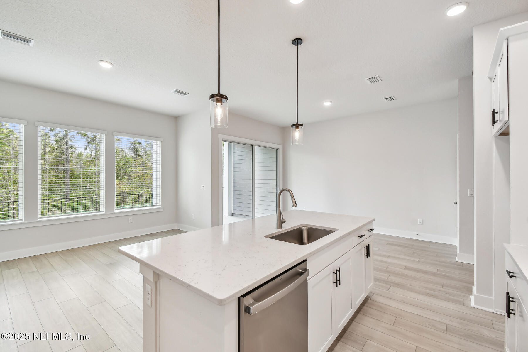 10057 Element Road Jacksonville, FL 32256 - Photo 8 of 25 a kitchen that has a sink a stove and a window with wooden floor
