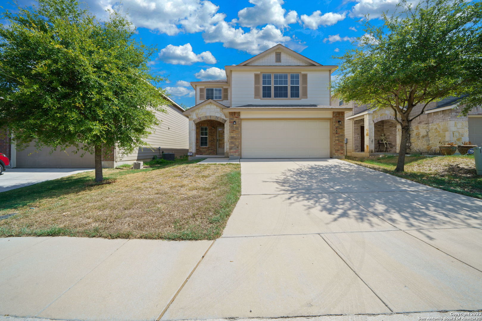 a front view of a house with a yard and garage