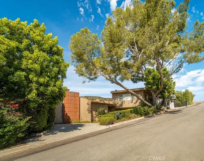 a front view of a house with a yard and a garage