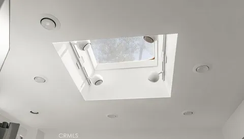 a view of an empty room with windows and outdoor space