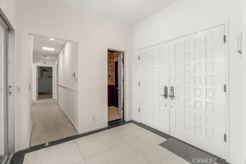 a bedroom with furniture and a large window