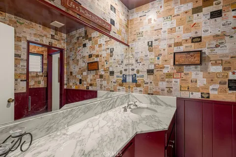 a bedroom with a bed and large windows