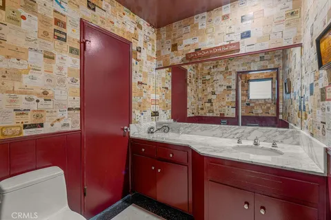 a bedroom with a large bed couch and windows