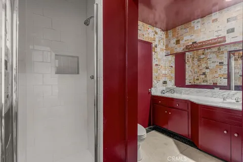 a bathroom with a shower and a glass door