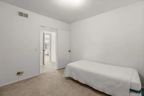 a bathroom with double vanity sinks a large mirror and a shower