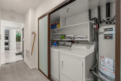 a bathroom with a granite countertop sink and a large mirror