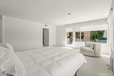 a spacious bedroom with a bed and a window