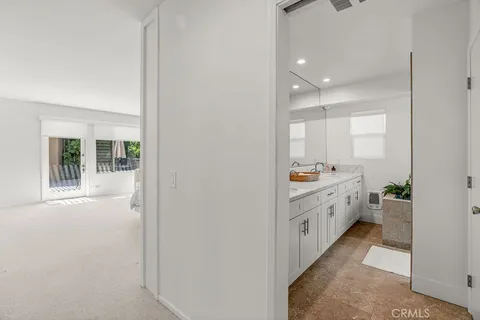 a view of a patio with table and chairs and wooden floor