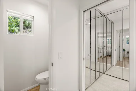 a living room with patio furniture and a potted plant