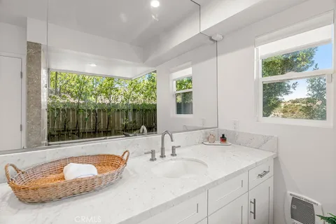 a living room with a bed furniture and next to a window