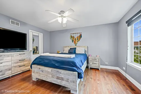 a bedroom with furniture and a flat screen tv
