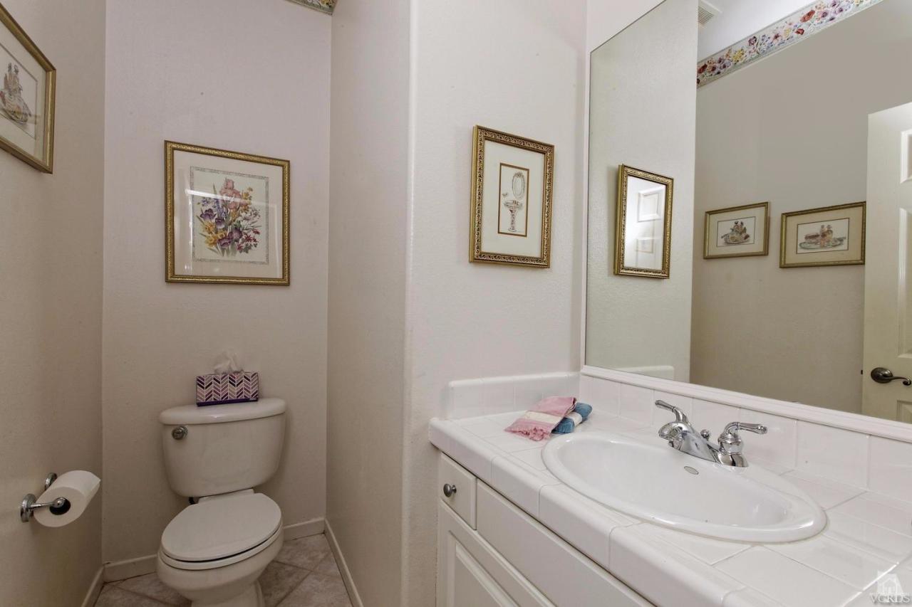 3248 Bluebird Circle Simi Valley, CA 93063 - Photo 11 of 28 a bathroom with a toilet a sink and mirror