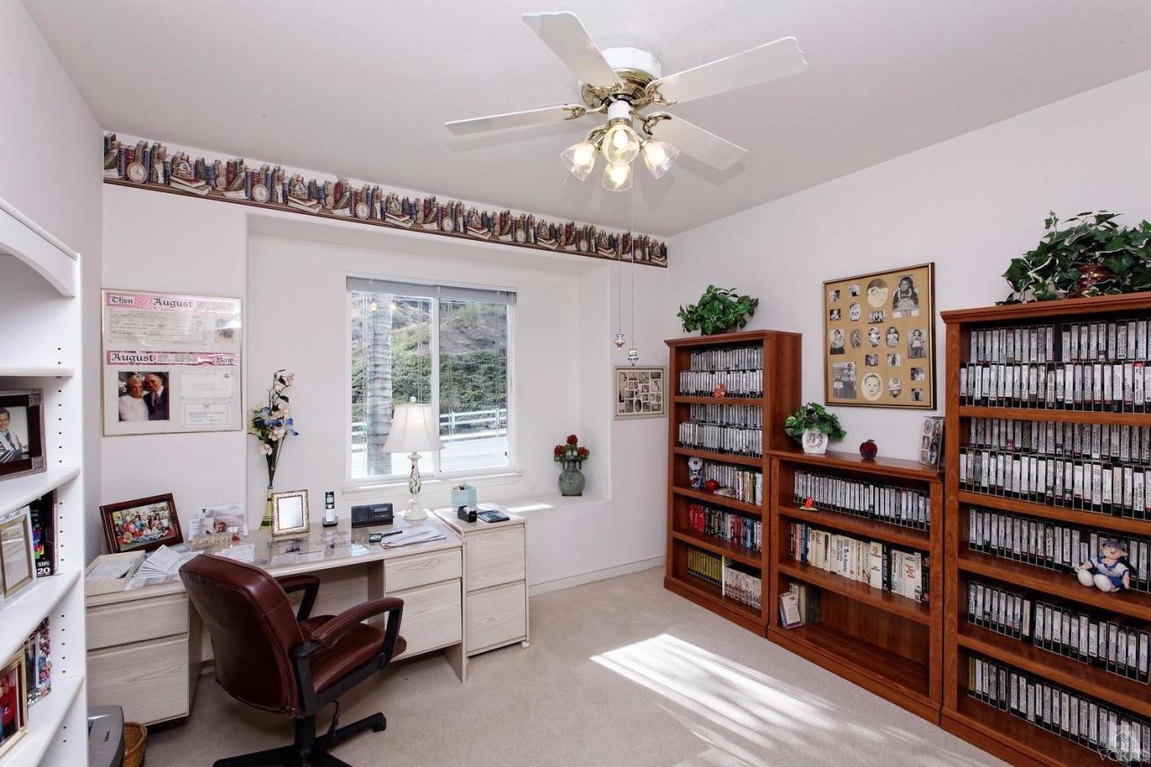 3248 Bluebird Circle Simi Valley, CA 93063 - Photo 12 of 28 a living room with furniture a bookshelf and a window