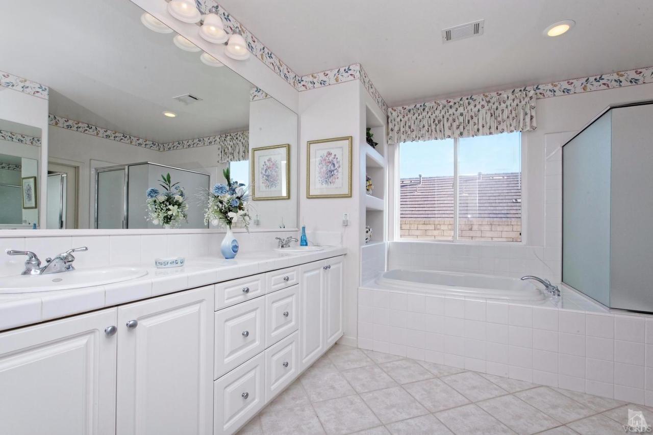 3248 Bluebird Circle Simi Valley, CA 93063 - Photo 18 of 28 a spacious bathroom with a double vanity sink a mirror a bathtub and next to a window