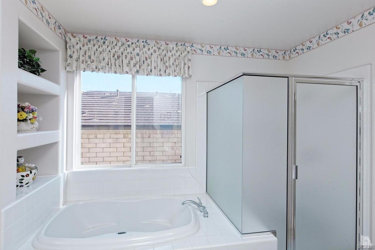 3248 Bluebird Circle Simi Valley, CA 93063 - Photo 19 of 28 a bathroom with a bathtub and a shower