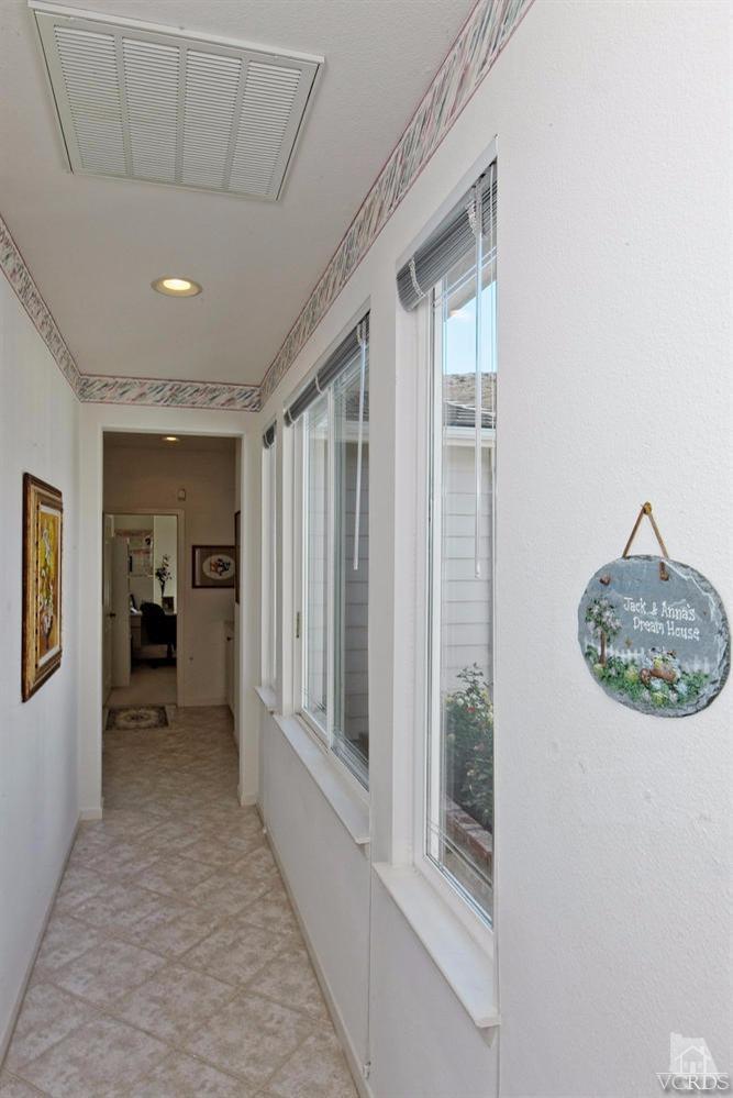 3248 Bluebird Circle Simi Valley, CA 93063 - Photo 21 of 28 a view of a hallway with windows and chandelier