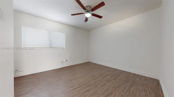 a bedroom with a bed and a potted plant