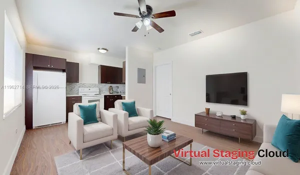 a living room with furniture a rug and a chandelier