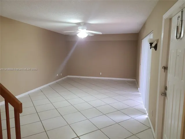 a view of a room with white walls and tiles