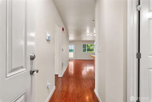a view of hallway with wooden floor
