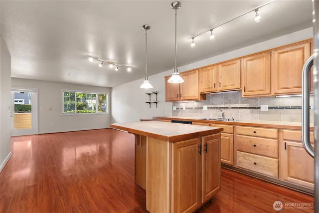 a kitchen with a stove a sink and a refrigerator
