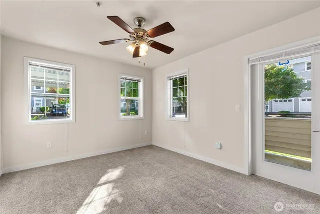a view of a livingroom with a ceiling fan and window